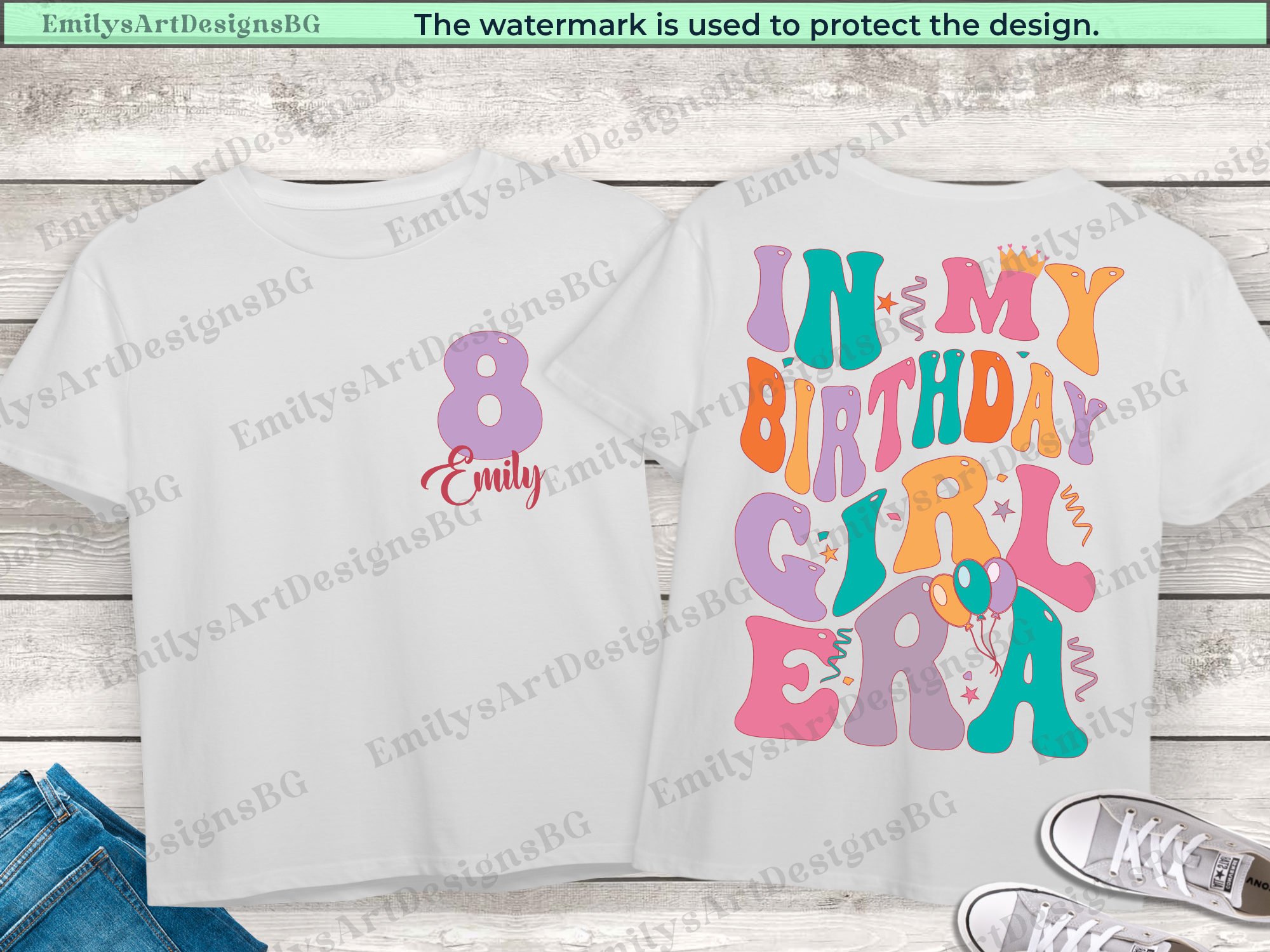 White t-shirt with colorful text design on a wooden surface