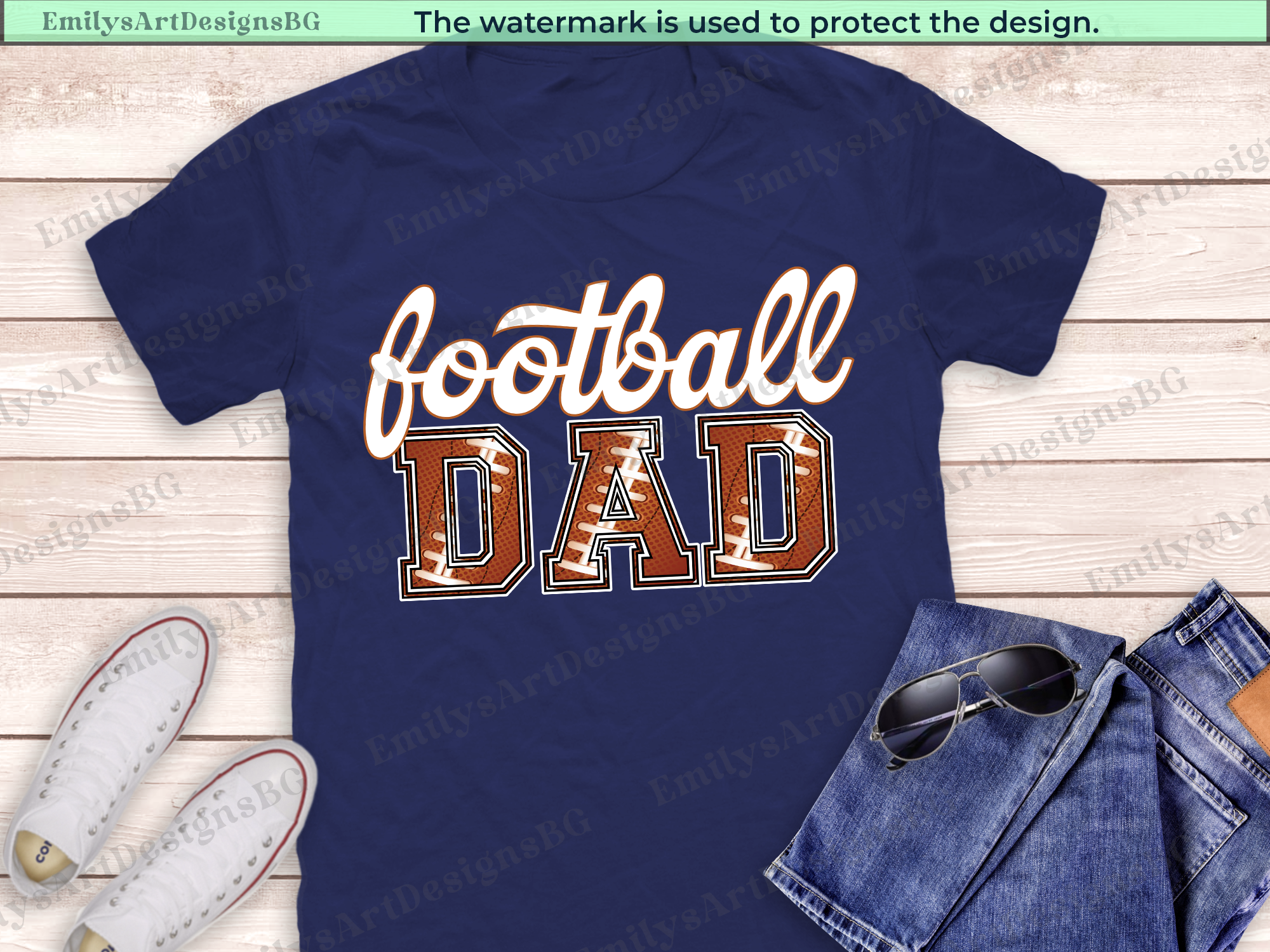 Navy blue t-shirt with 'football DAD' text on a wooden surface with jeans and sunglasses.