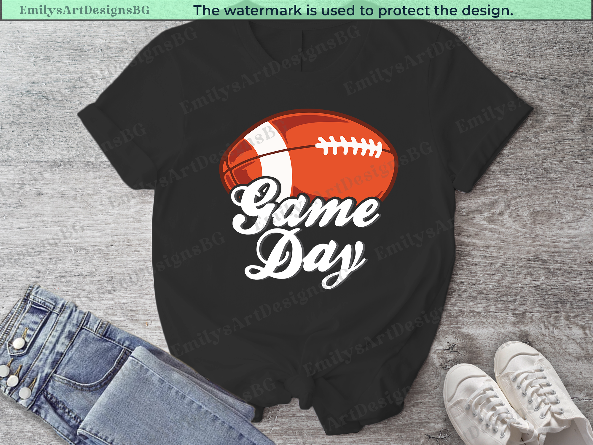 Black t-shirt with football graphic and 'Game Day' text on a wooden surface with jeans and shoes.