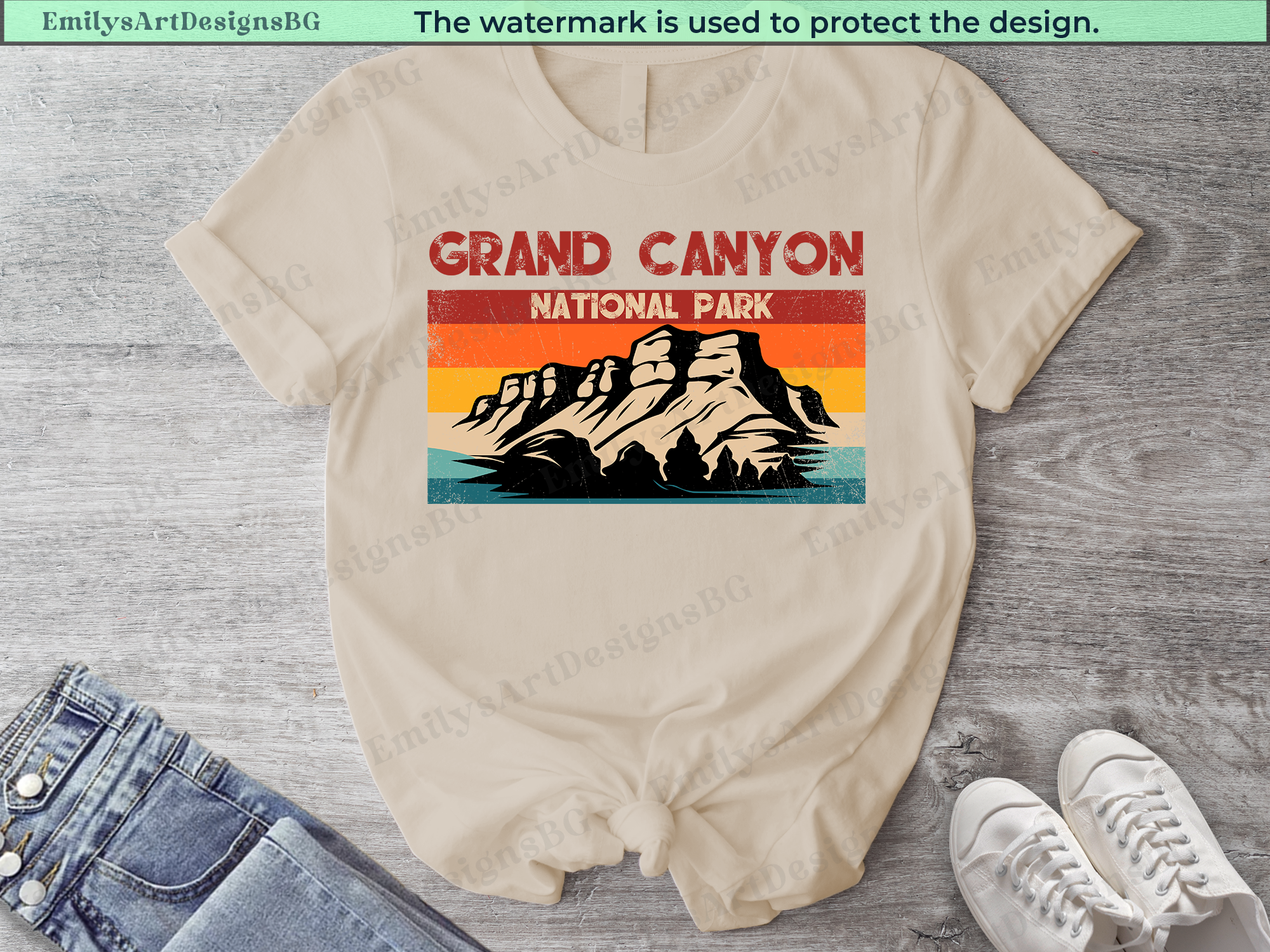 Beige t-shirt with Grand Canyon National Park graphic on a wooden surface with jeans and sneakers.