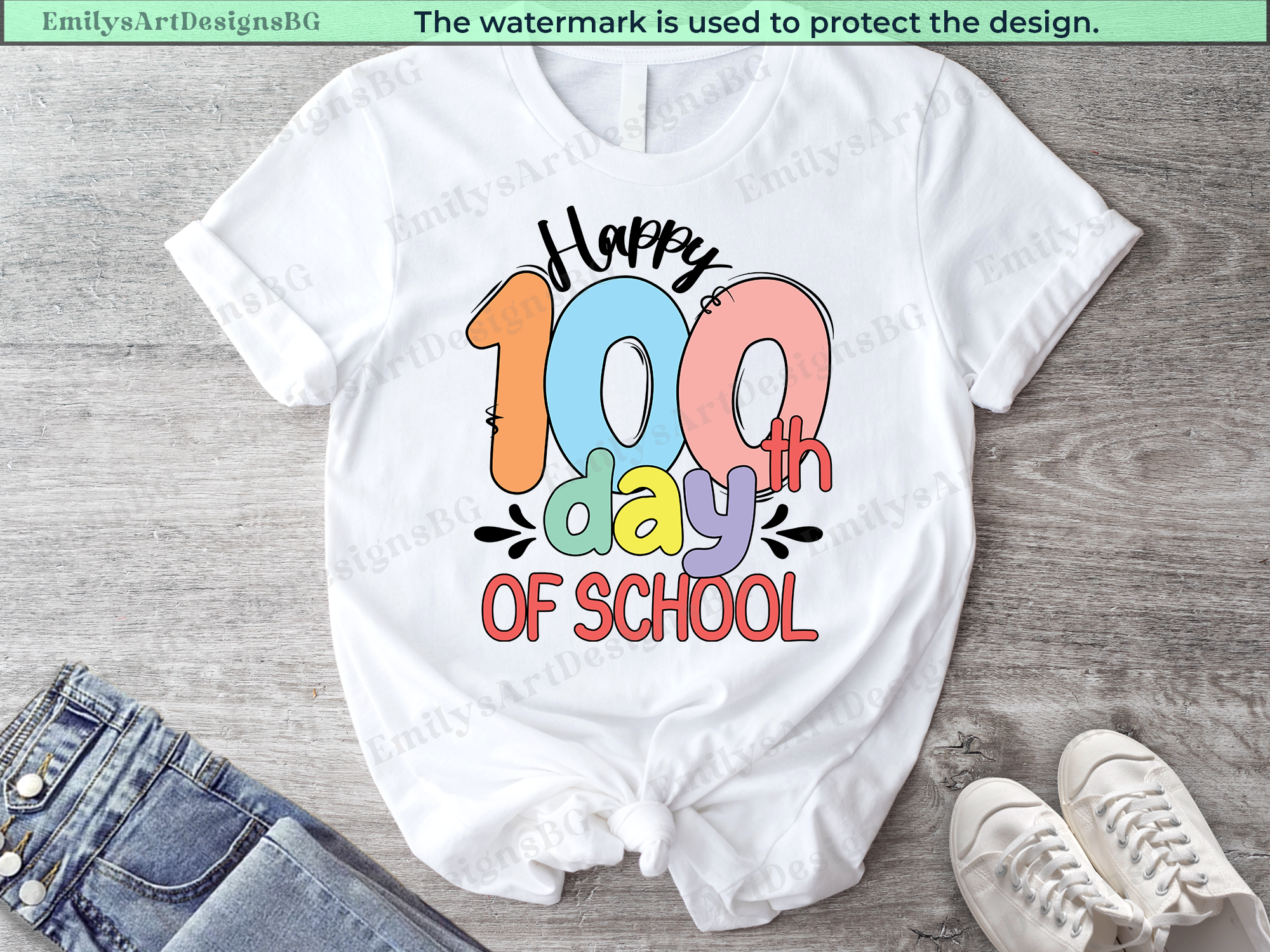 White t-shirt with 'Happy 100th Day of School' design on a wooden surface.