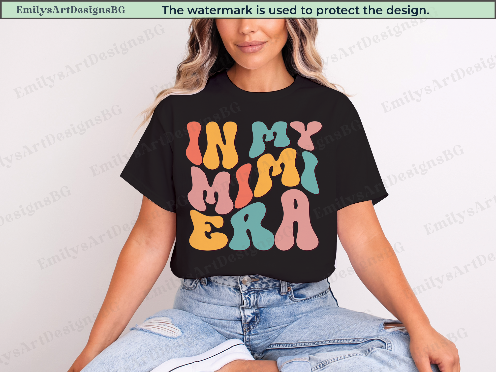 Person wearing a black t-shirt with colorful text 'IN MY MIMI ERA' on a light gray background.