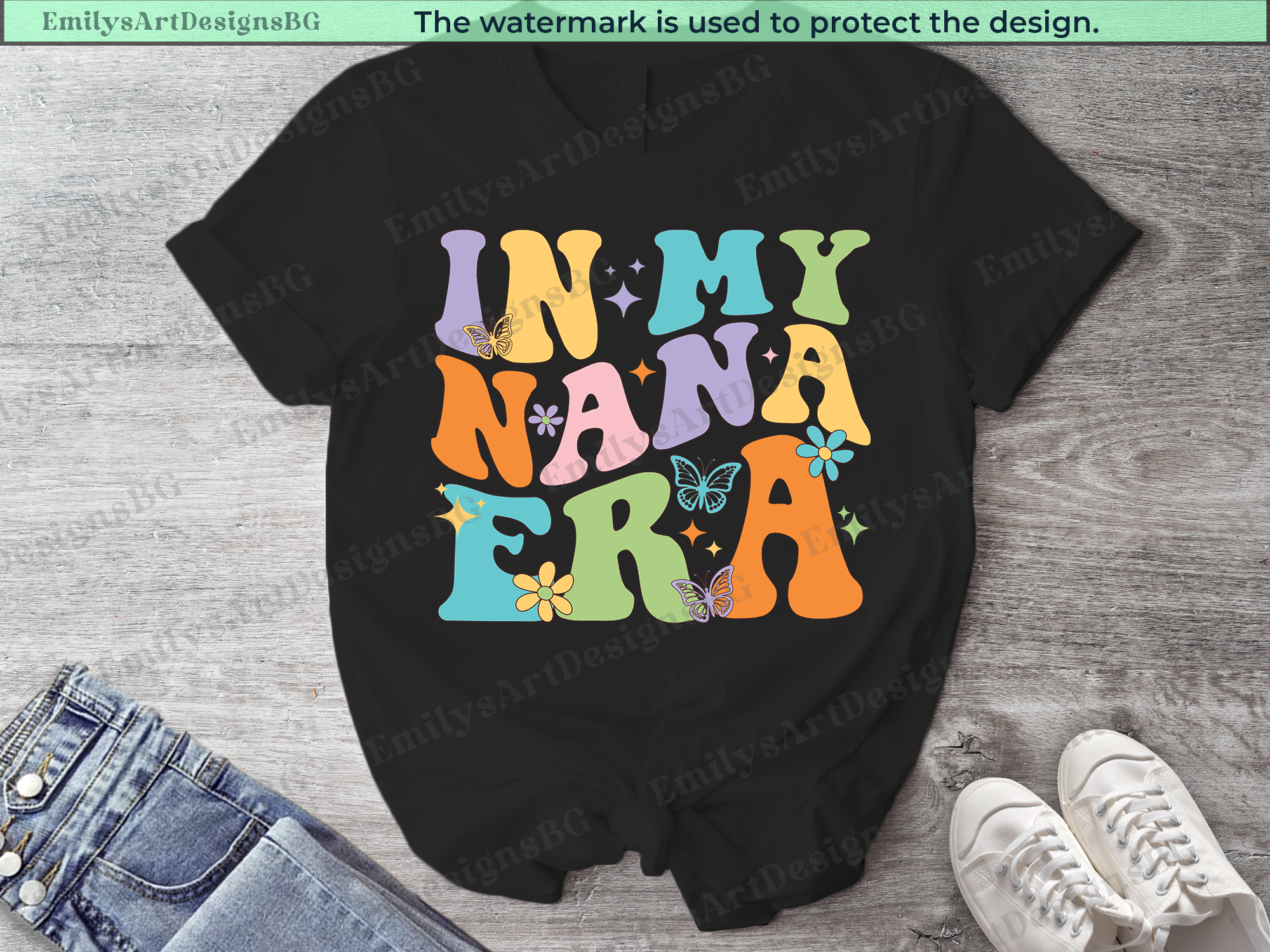 Black t-shirt with colorful 'IN MY NANA ERA' text design on a wooden surface.