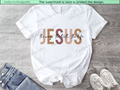 White baby romper with 'Jesus the way, the truth, the life' text on a wooden surface.